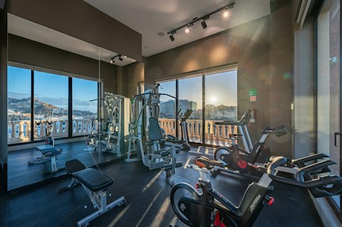 Train in the on-site gym with views of the marina