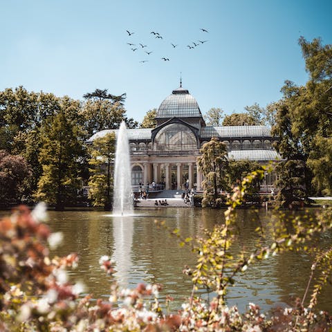 Stroll around the greenery in El Retiro Park – an eighteen minute walk away
