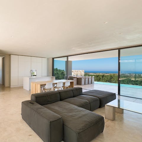 Take five in the bright and airy living space with gorgeous sea views