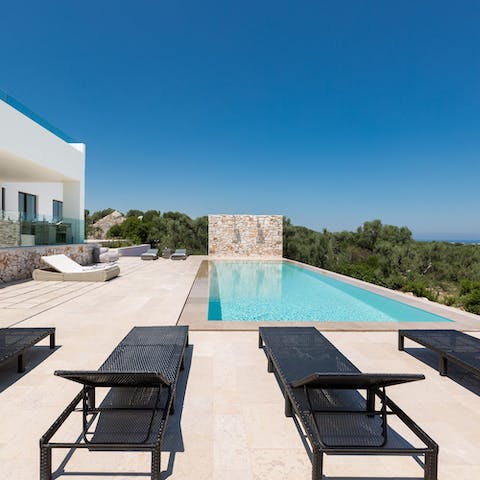 Laze on sun loungers before cooling off with a dip in the infinity pool