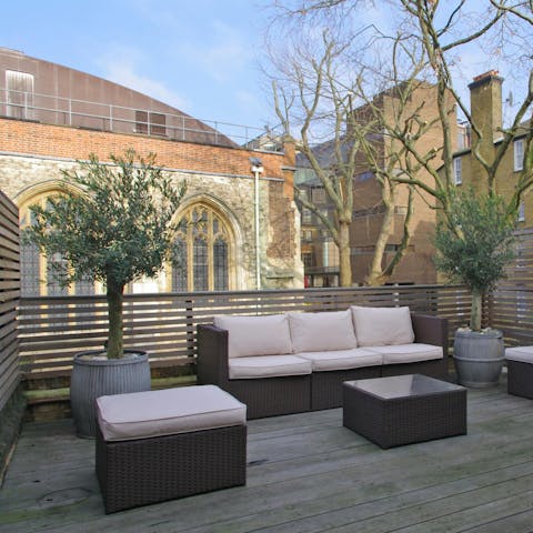 Unwind on the roof terrace amid olive trees and fairy lights