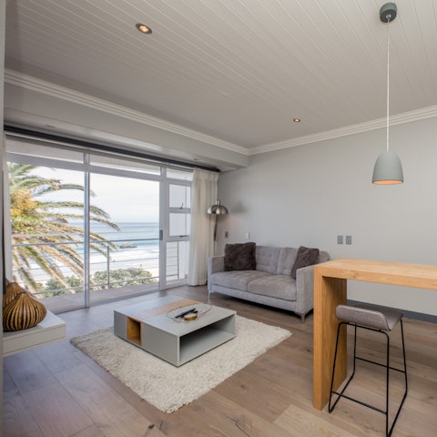 Unwind in your light-filled living room, accompanied by palm tree vistas