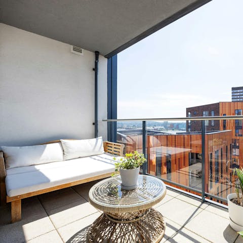 Sip your morning coffee on the sun-kissed balcony with views out to Canary Wharf