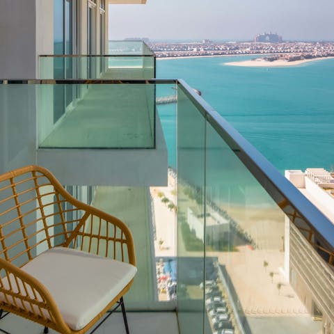 Admire the views over the sea to the Palm Jumeirah from the private balcony