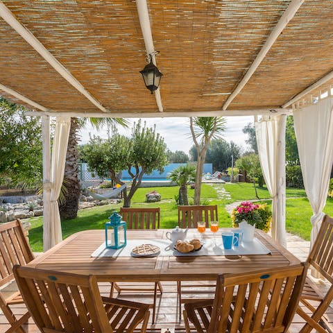 Gather around the dining set on the covered terrace for cocktails and crudites at sunset