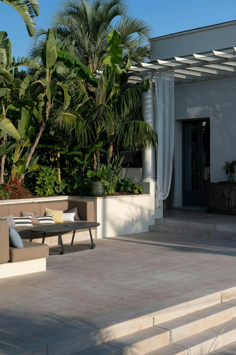 Gather for evening drinks amid the Mediterranean palms and gardens