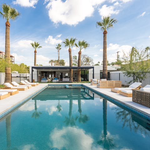 Float in the fifty foot pool surrounded by palm trees
