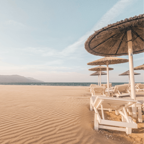 Sink your feet into the sand at Golden Beach, just a thirty-minute drive away