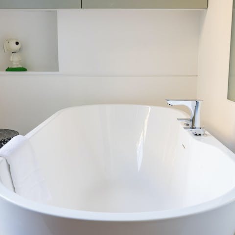 Luxuriate in the standalone bath tub after a busy day in the city