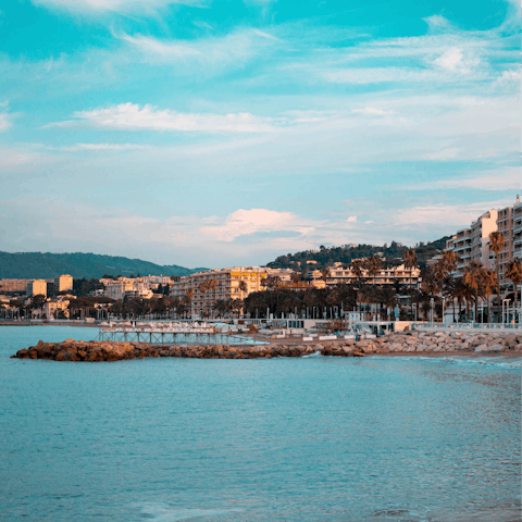 Discover the stunning palm-lined beaches of Cannes, just a short drive from your apartment