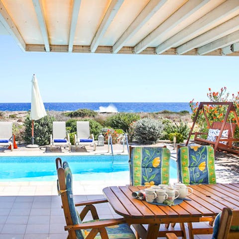 Enjoy alfresco meals on the covered terrace as you look out to sea