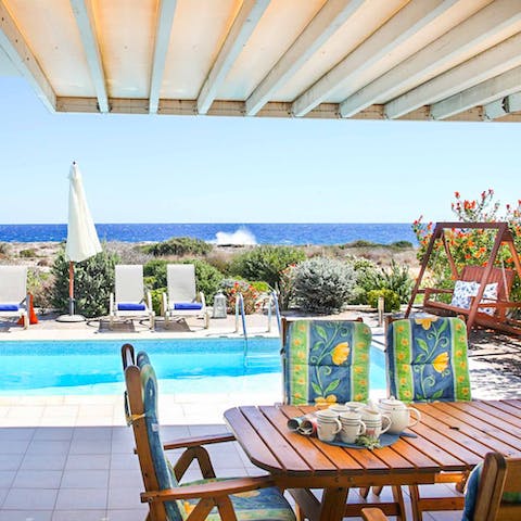 Enjoy alfresco meals on the covered terrace as you look out to sea