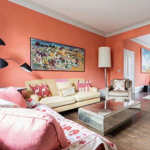 Snuggle up with a book in the tangerine-coloured lounge