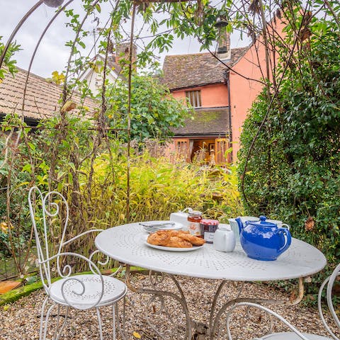 Sit out underneath the vine-covered bower and admire the Tudor knot garden