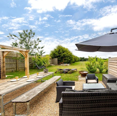 Enjoy an alfresco dinner with views across the generous gardens