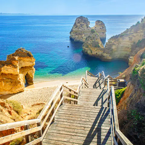 Paddle the pristine waters of Praia do Meco, a seven-minute drive away