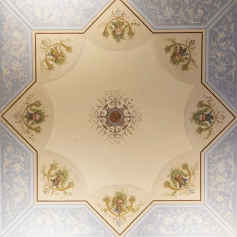 Admire the beautiful frescoes in this elegant home