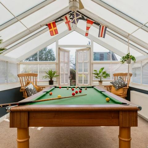 Challenge the competitive members of your group to a game of pool