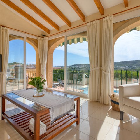Take in the scenery from the living room's floor-to-ceiling glass doors