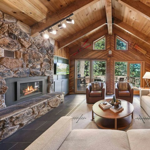 Unwind by the stone fireplace beneath vaulted ceilings