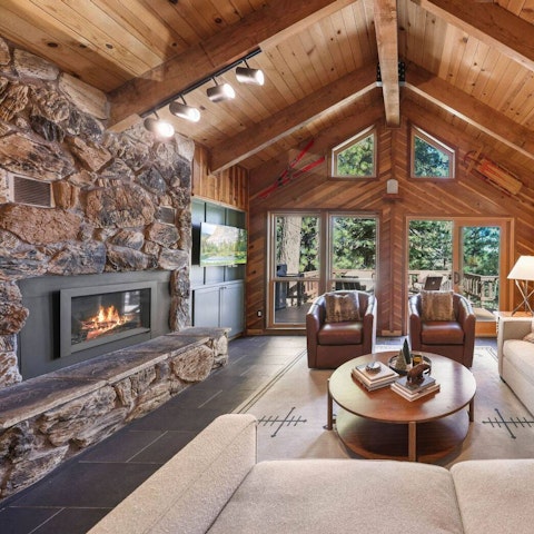 Unwind by the stone fireplace beneath vaulted ceilings