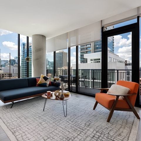 Enjoy the open plan living room and stunning city views from your balcony