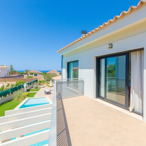 Head out onto the balcony to catch the sun setting over the Mediterranean Sea