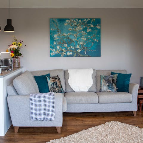 Curl up with a good book on the inviting corner sofa