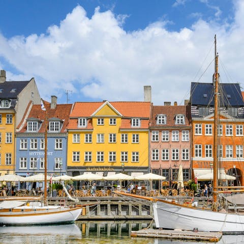 Watch Danish life go by from the nearby Nyhavn Harbour