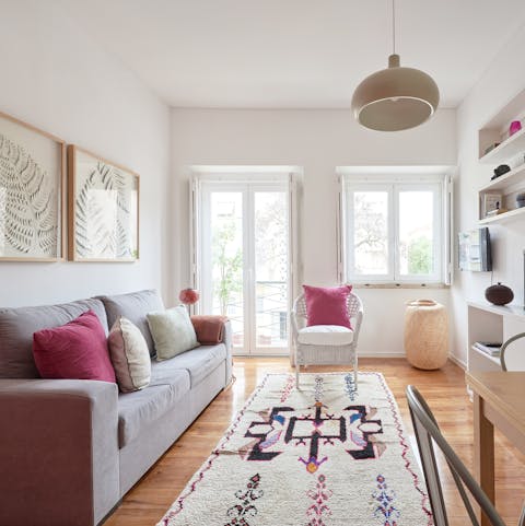 Relax in the bright living room with a glass of Portuguese wine after a day of exploring the city