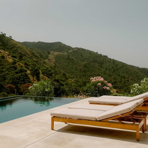 Lounge by the pool overlooking peaceful countryside