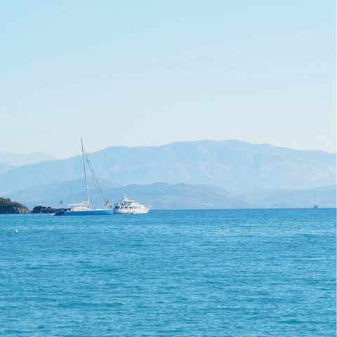 Drive ten minutes to Glyfada Beach to snorkel in the clear water