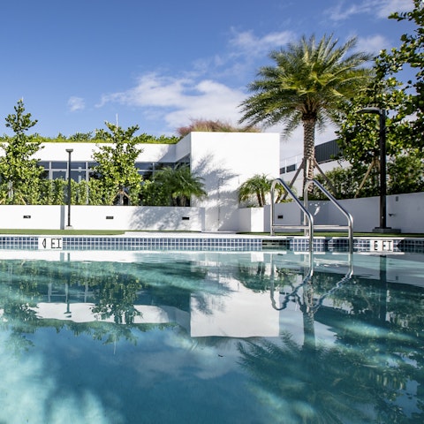 Beat the heat with a dip in the sparkling outdoor pool, circled by swaying palm trees
