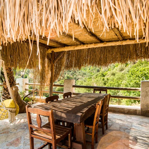 Enjoy alfresco meals under the thatched terrace