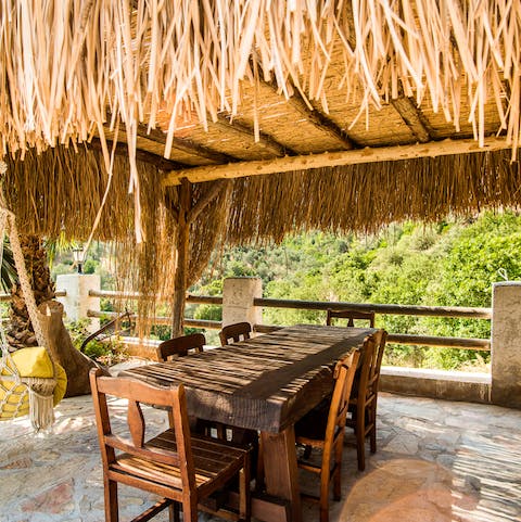 Enjoy alfresco meals under the thatched terrace
