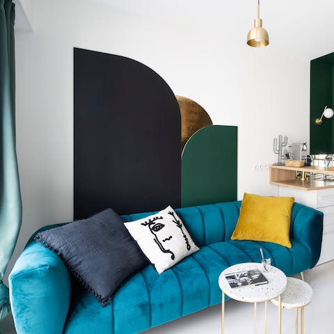 Get yourself cosy and snuggle up on the plush emerald sofa