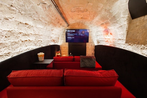 Screen films beneath centuries-old stone arches in the cellar