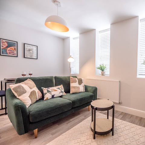 Curl up on the forest green sofa with a glass of something sparkling