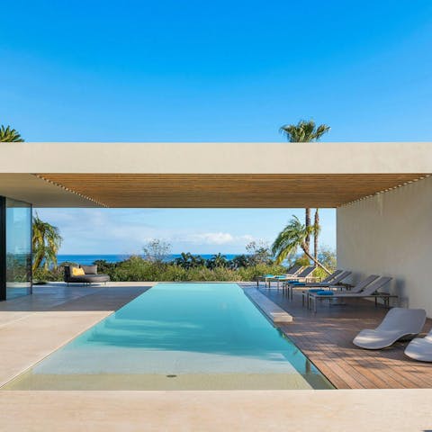 Unwind by the infinity pool with views stretching to Mount Etna