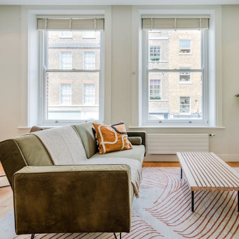 Relax in the bright living room with a glass of wine after a day of exploring