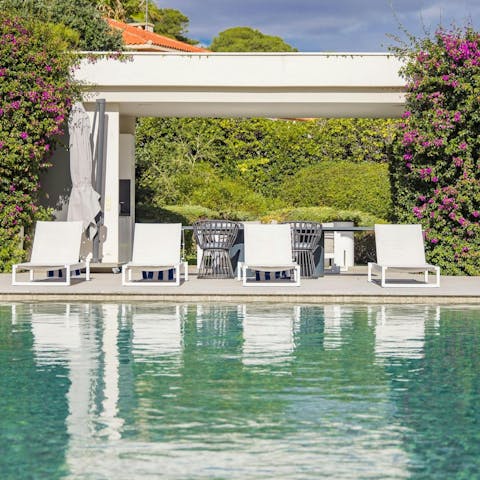 Admire the peace and tranquility of this home as you lay poolside