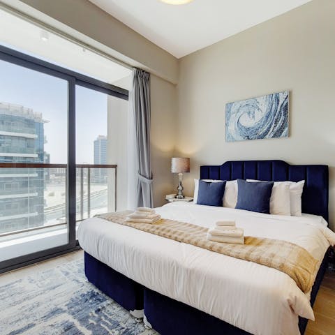 Gaze out at the views over the cityscape through the floor-to-ceiling windows in the bedroom