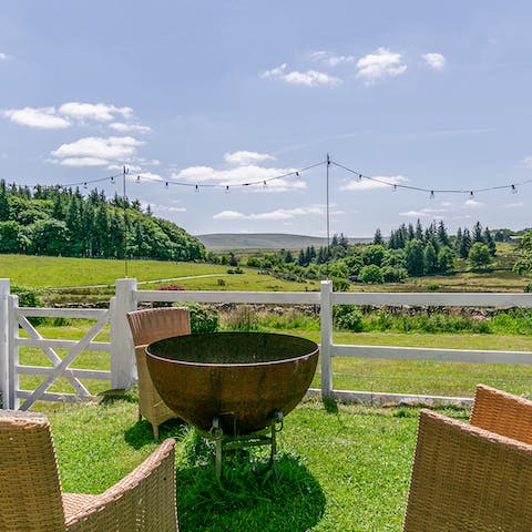 Gather around the fire pit and watch the sun set over Dartmoor National Park