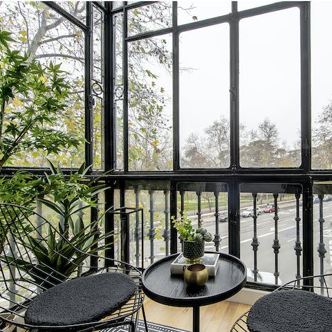 Take a seat in the terrarium-style balcony and watch the world go by