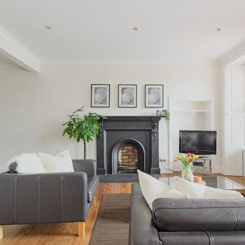 Gather around the original fireplace in the living room