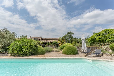 Savour a glass of pink rosé wine as you unwind by the pool