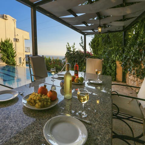 Dine alfresco under the pergola as the sun dips below the horizon