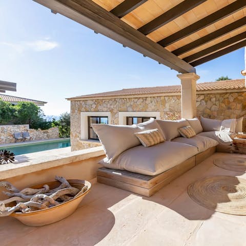 Sink into your outdoor sofas under the shade of the pergola