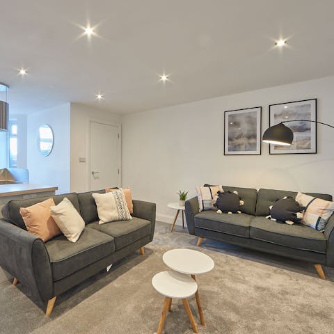 Kick back in the open-plan living room with a glass of wine after a day of sea and sun