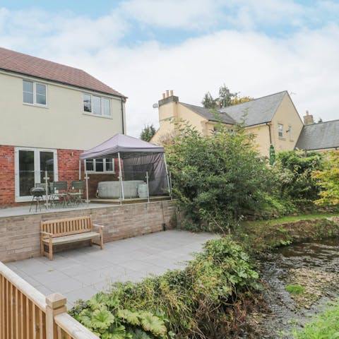 Relax in the hot tub in the garden with its stream and countryside views